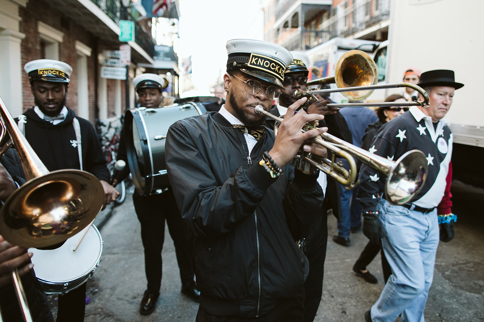 Private second line brass band leading an investor group through the French Quarter